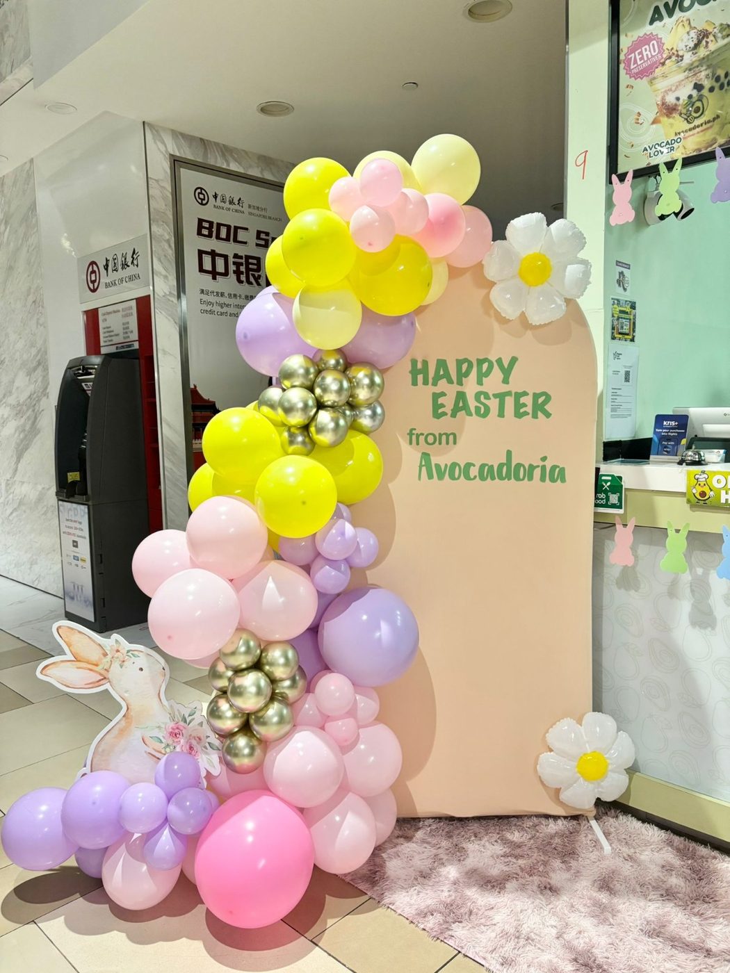 In-store Easter event styled for Avocadoria — pastel balloon backdrop